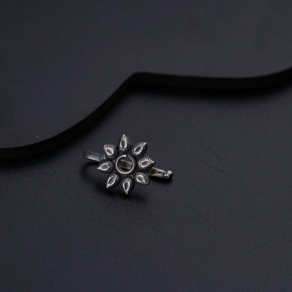 a silver ring with a flower design on it