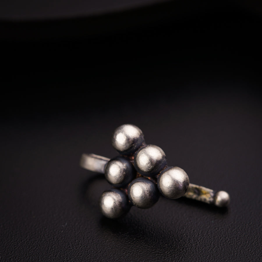 a bunch of silver balls sitting on top of a black surface