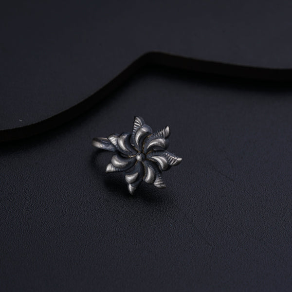 a close up of a metal object on a black surface