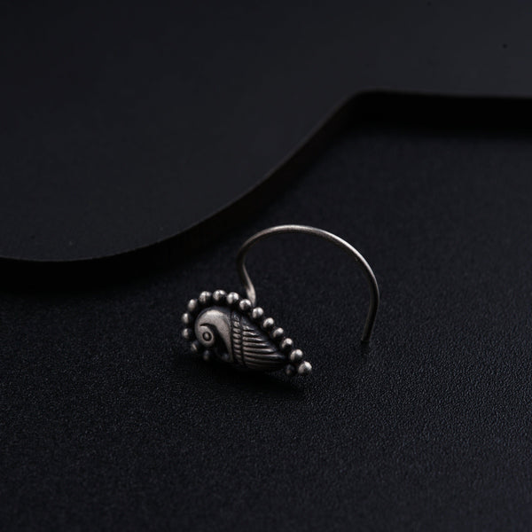a close up of a pair of earrings on a black surface