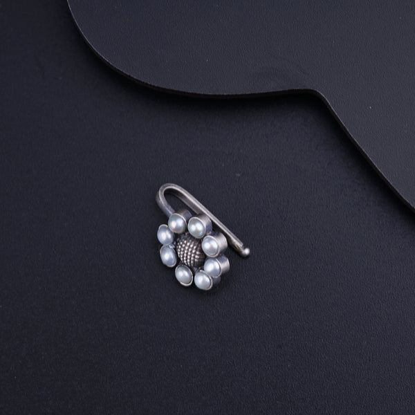 a close up of a pair of earrings on a black surface