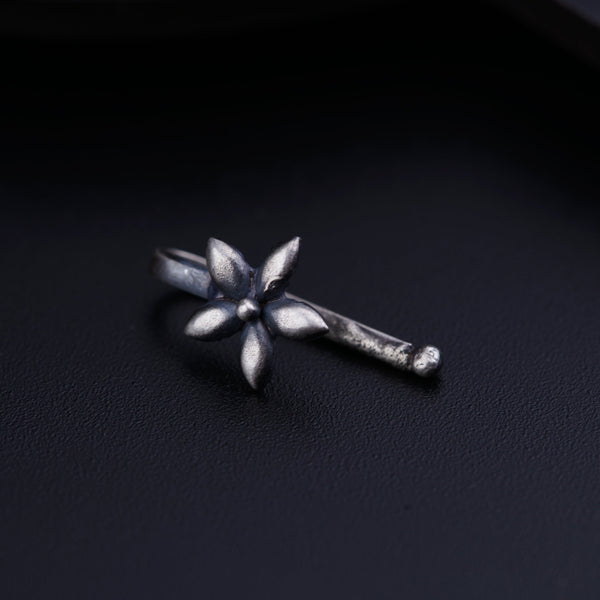 a close up of a metal object on a black surface
