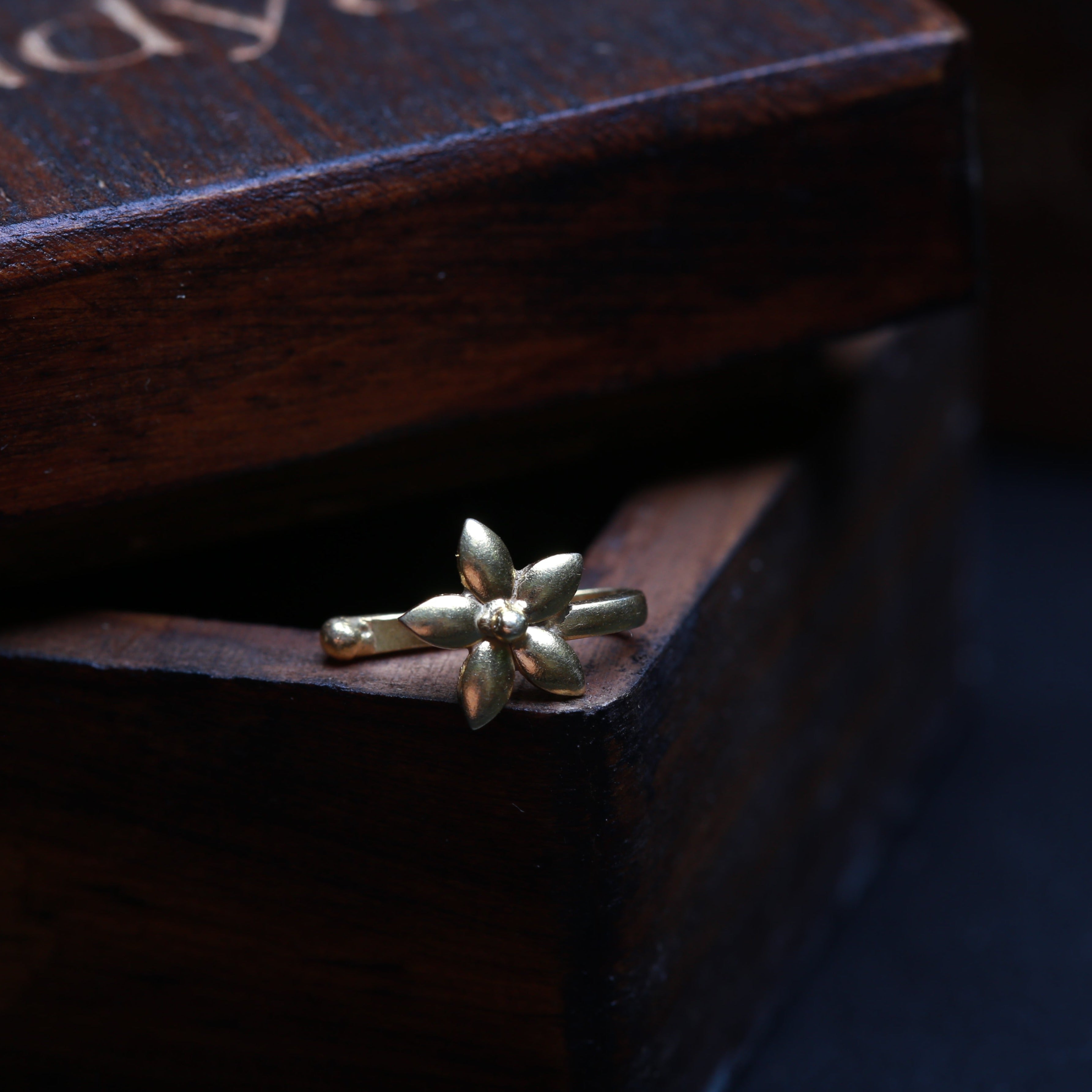 a close up of a ring on a wooden box