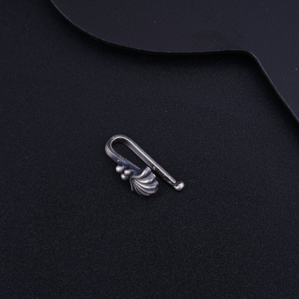 a metal hook on top of a black surface
