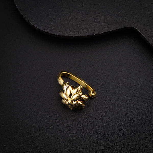 a gold ring sitting on top of a black surface