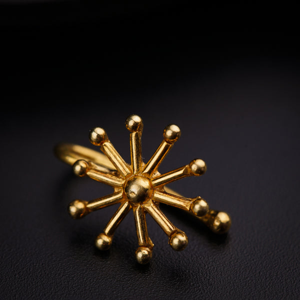 a close up of a gold ring on a black surface