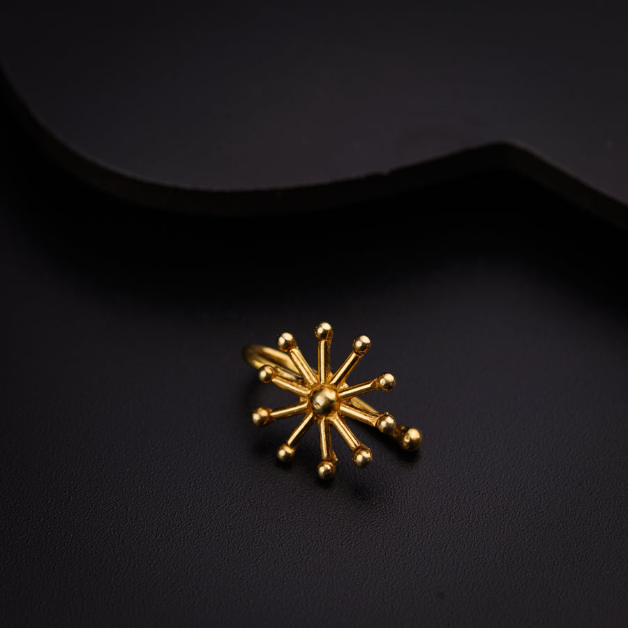 a small gold snowflake on a black surface