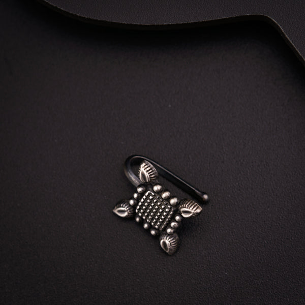 a close up of a metal object on a black surface