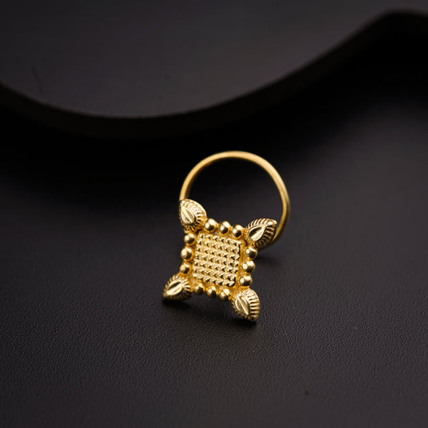 a close up of a gold ring on a black surface