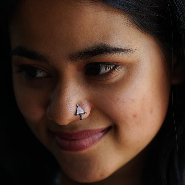a close up of a person with a nose piercing