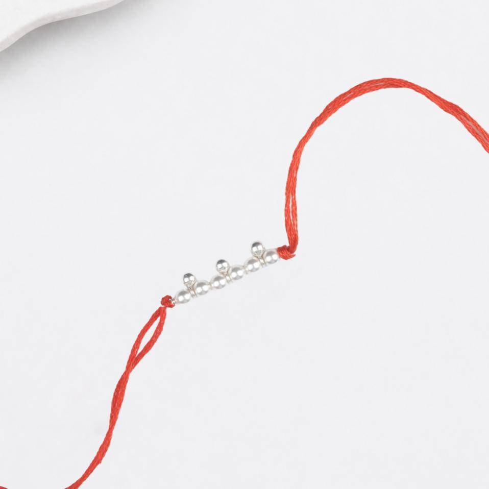 Close-up of Pearl & Silver Bead Rakhi craftsmanship