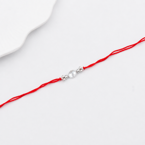 Elegant baroque pearl Rakhi with silver beads for brother