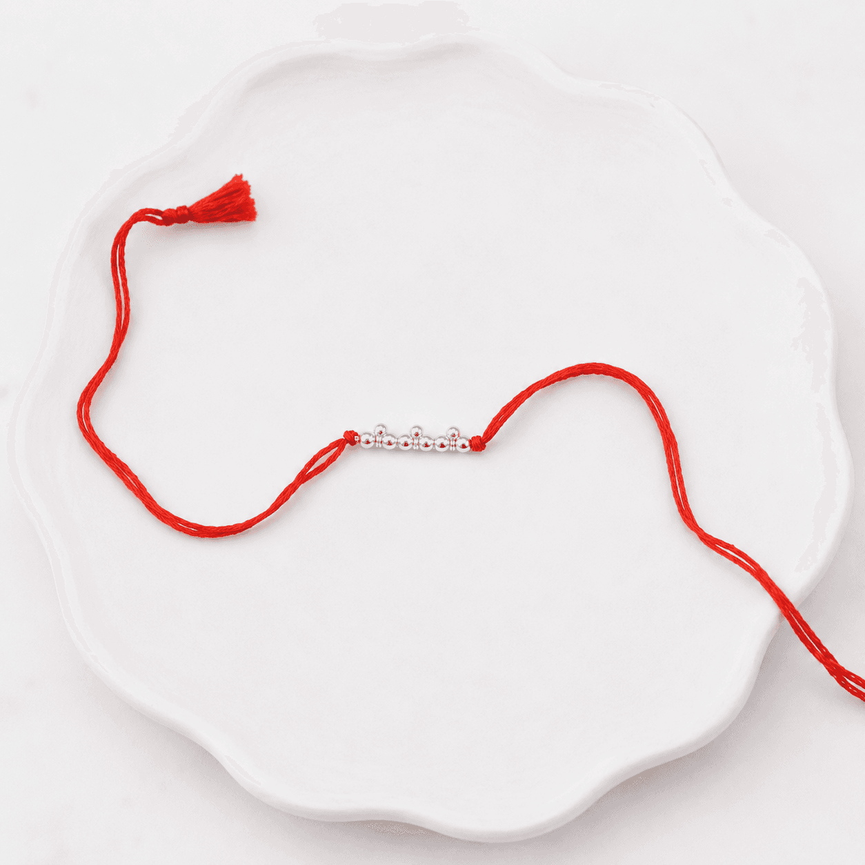 Elegant pearl and silver Rakhi for brother