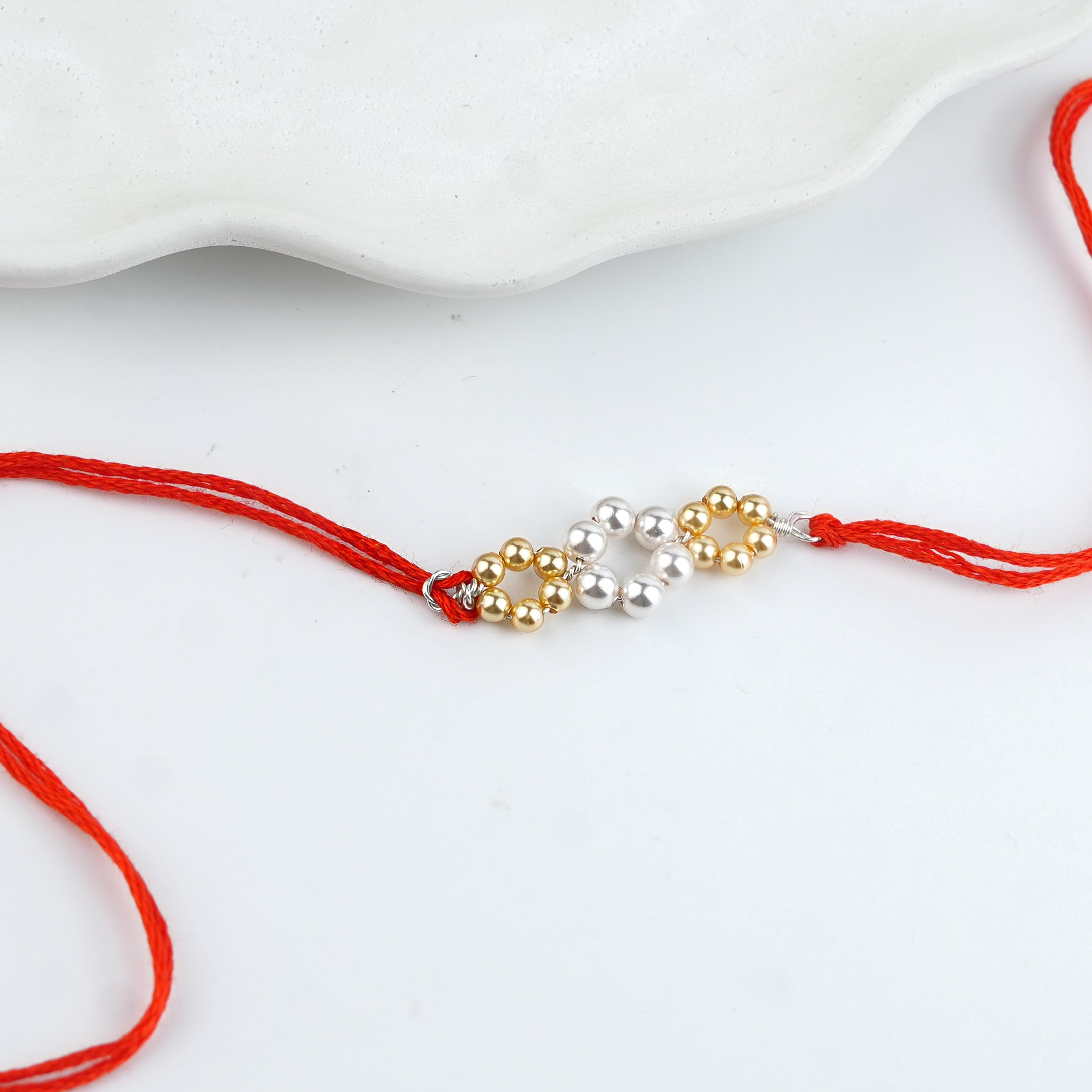 Golden & White Pearl Handmade Silver Rakhi