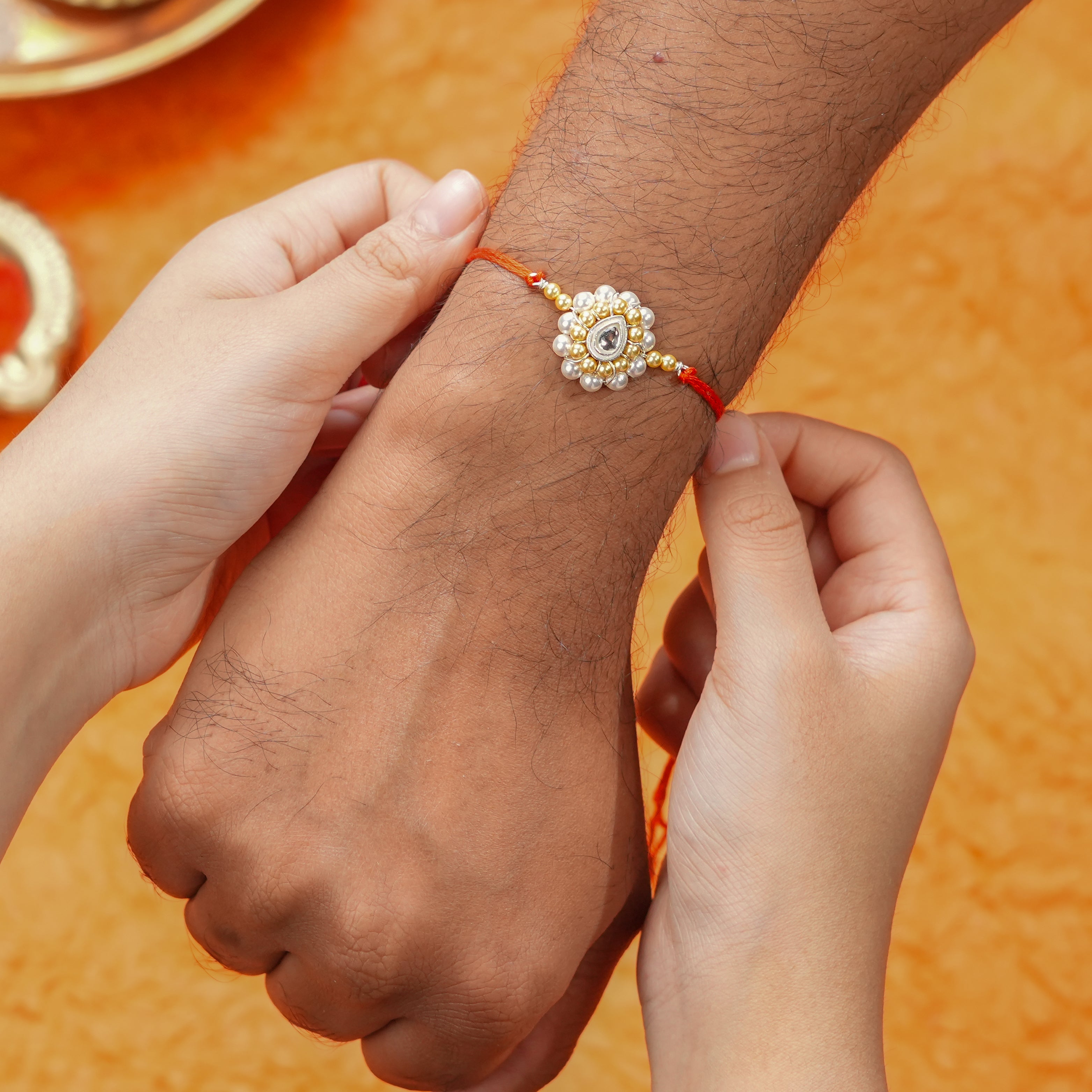 CZ Drop, Golden & White Pearl Handmade Silver Rakhi