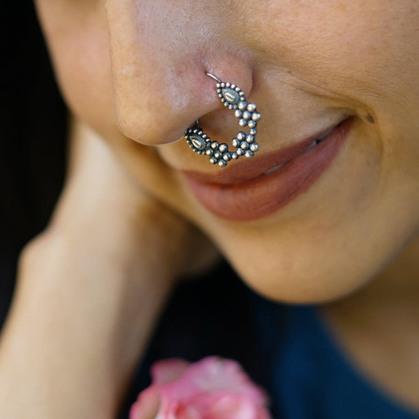 a close up of a person with a nose ring