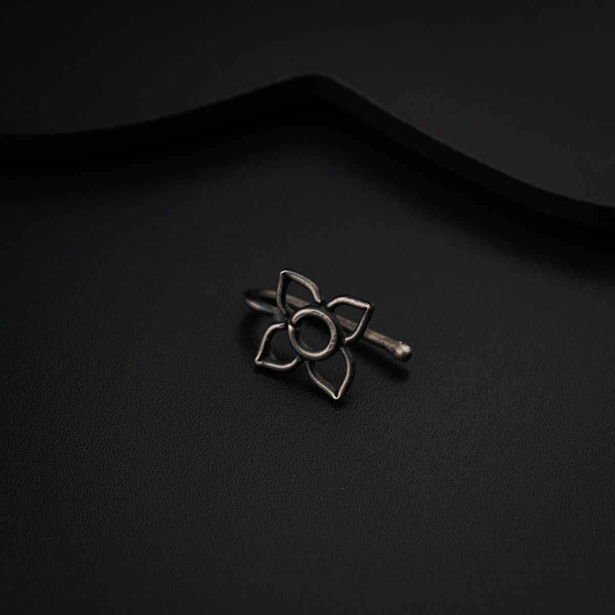 a metal object sitting on top of a black surface