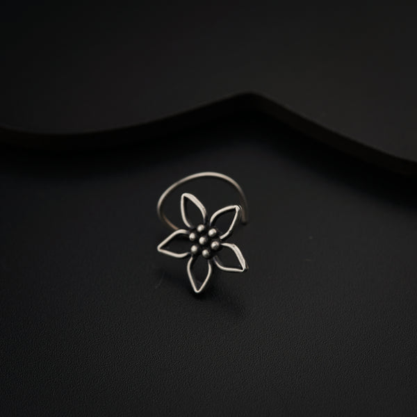 a silver ring with a flower on it