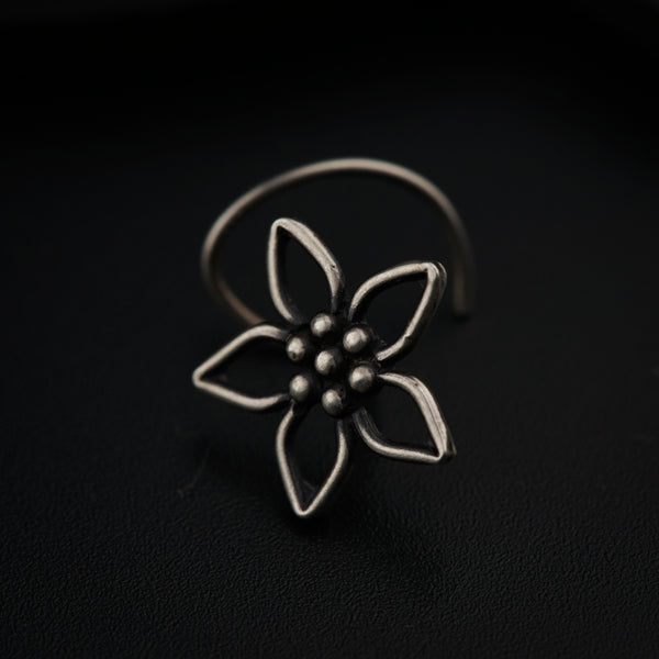 a silver ring with a flower on it