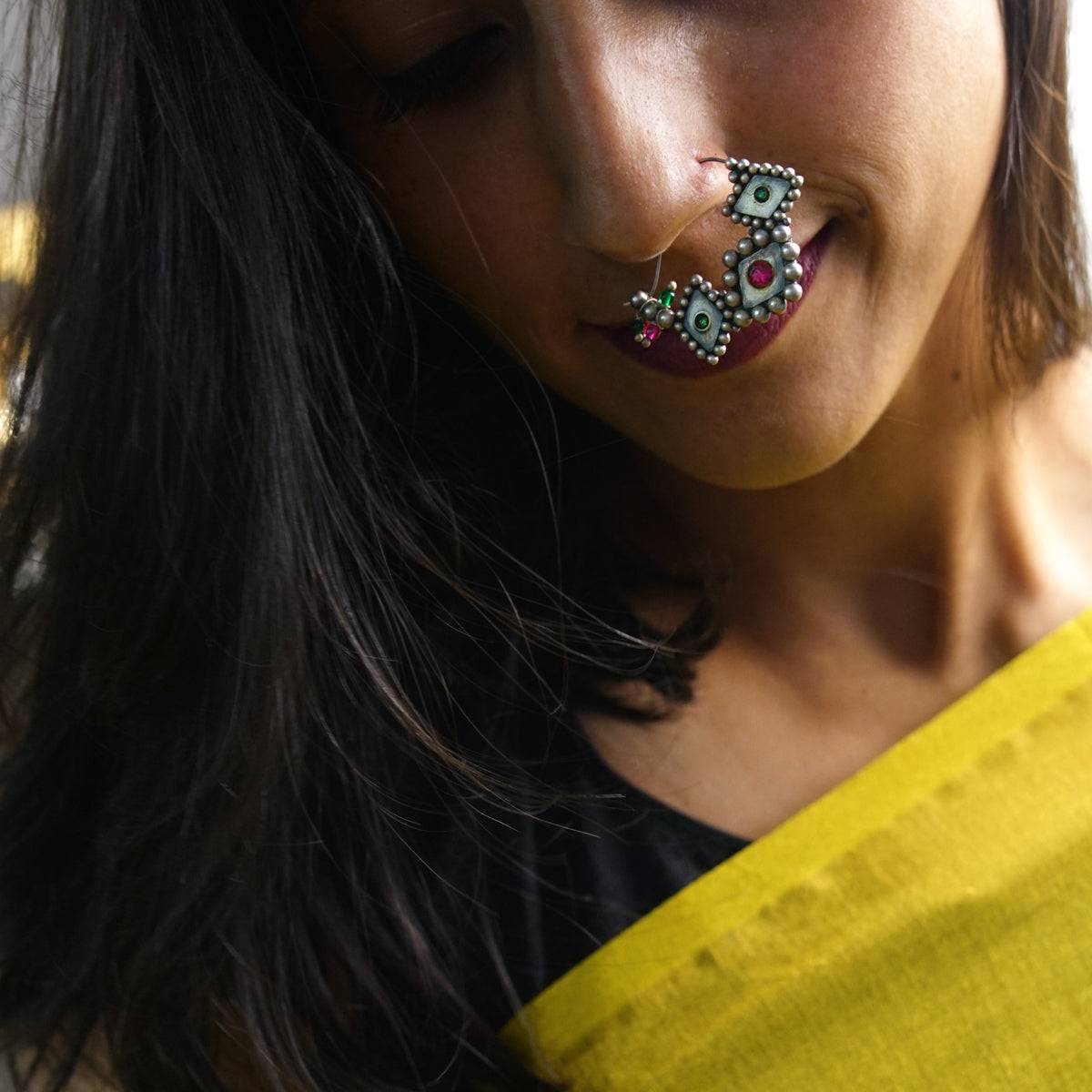 a close up of a person with a nose ring