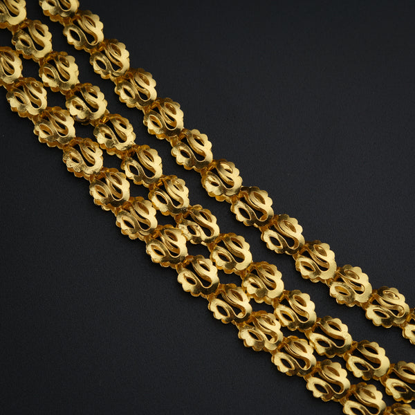 a close up of a gold chain on a black background