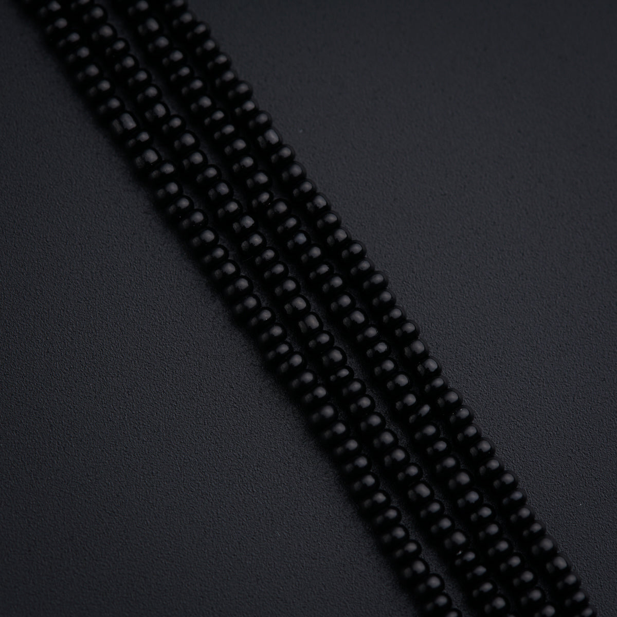 a close up of a black beaded necklace