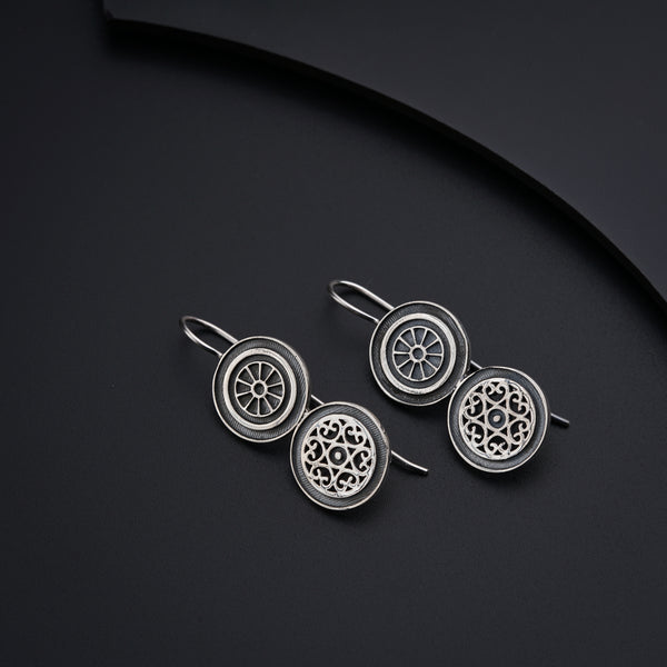 a pair of earrings sitting on top of a table