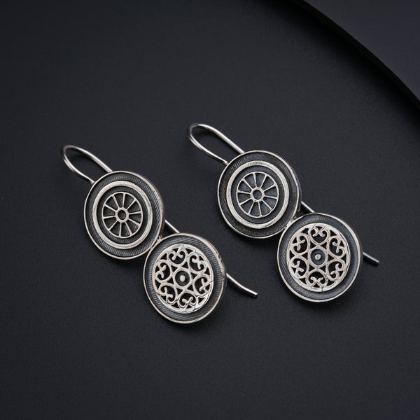a pair of earrings sitting on top of a table