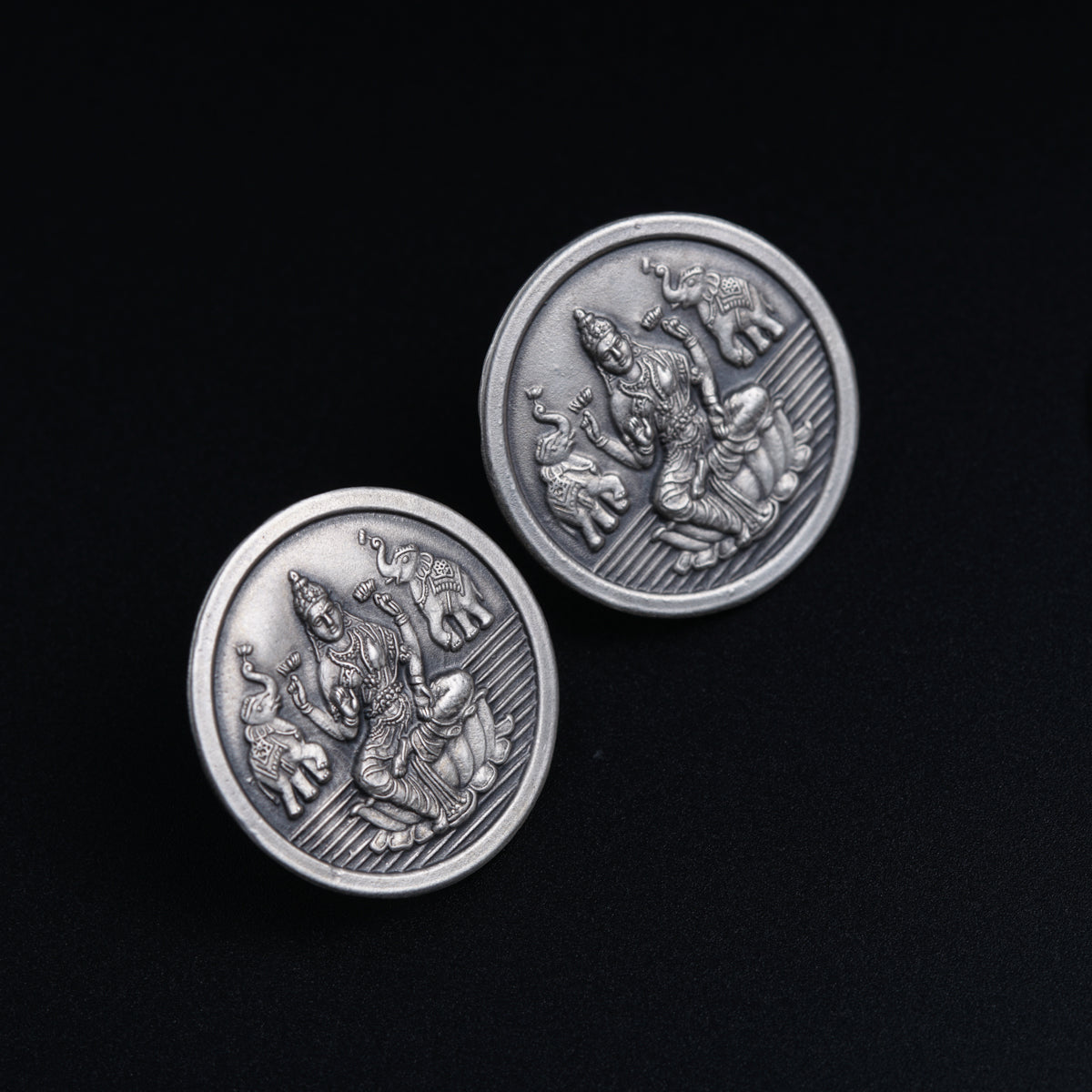 a pair of silver coin sitting on top of a table
