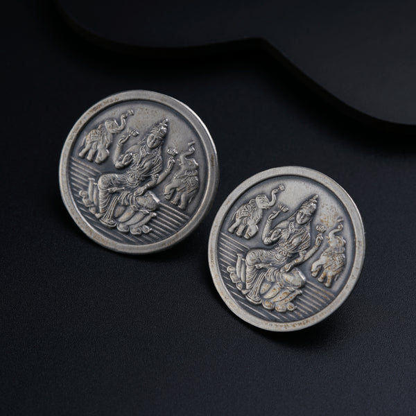 a close up of two metal buttons on a black surface