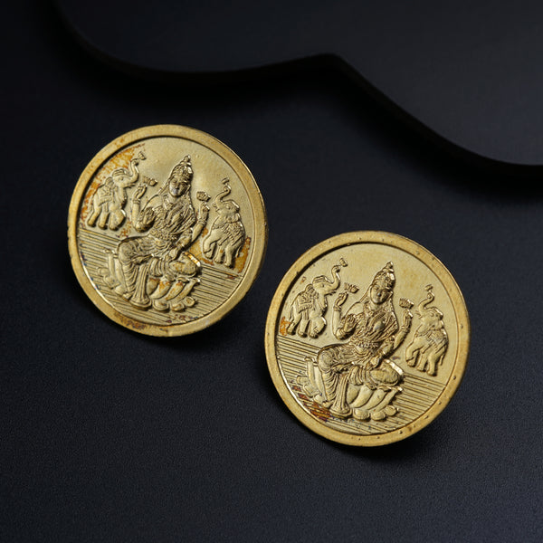 a pair of gold coins sitting on top of a table