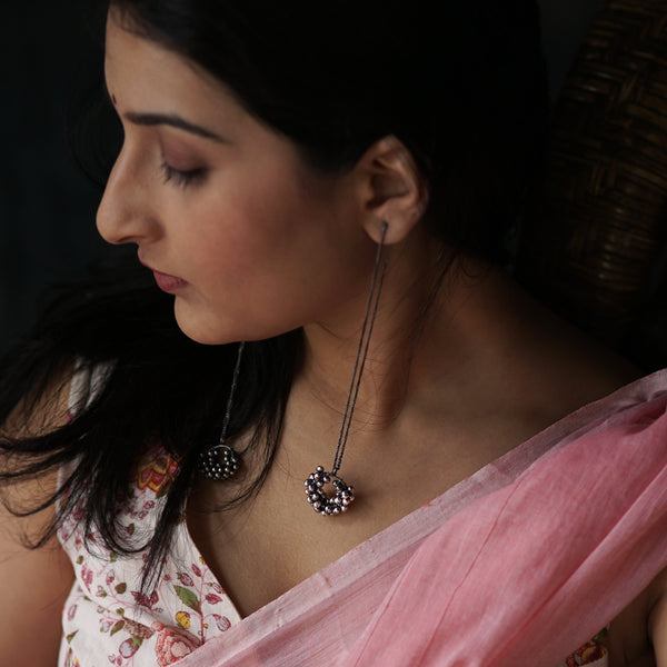 Kashmir Dejhoor Ghungroo earrings with oxidized silver finish on woman in traditional attire