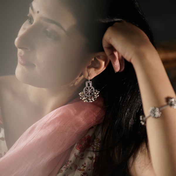 Silver chakra filigree earrings with ghungroo close-up detailing