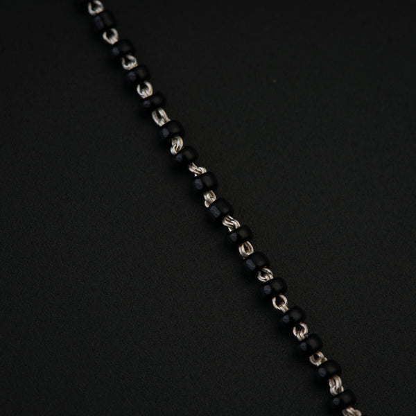 a close up of a chain on a black surface