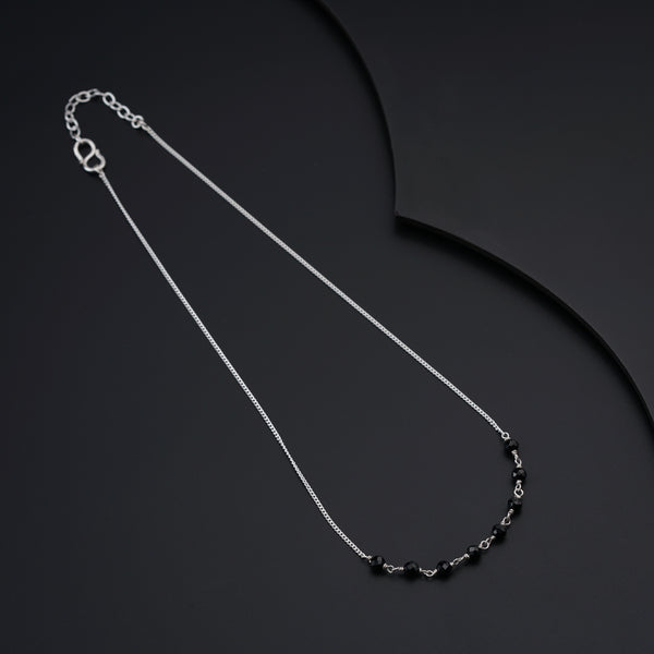 a black and white necklace on a black background