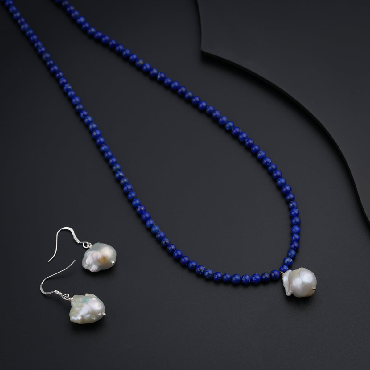 a necklace and earring set with blue beads