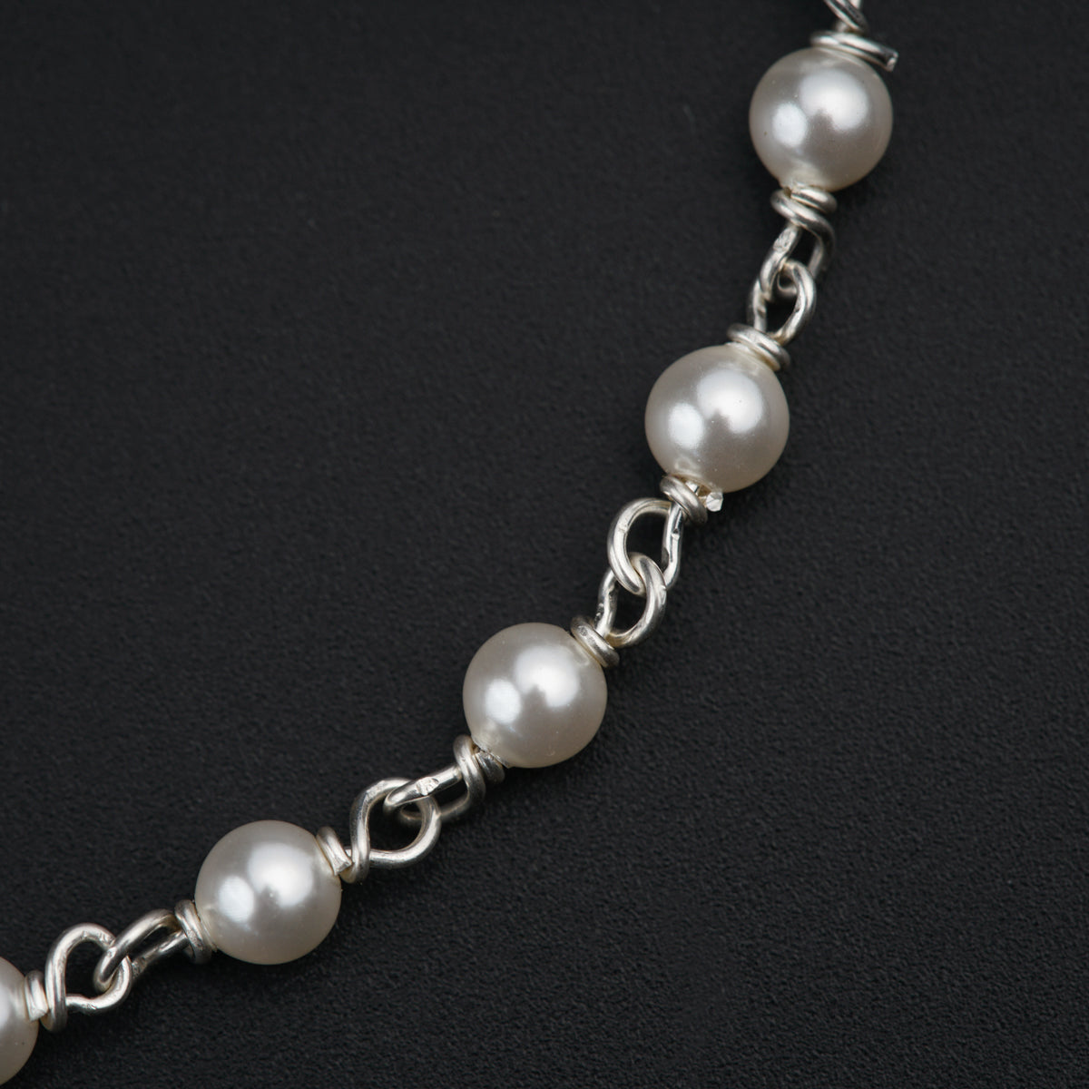 a white pearl necklace on a black background