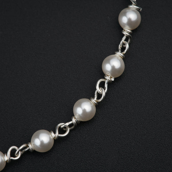 a white pearl necklace on a black background