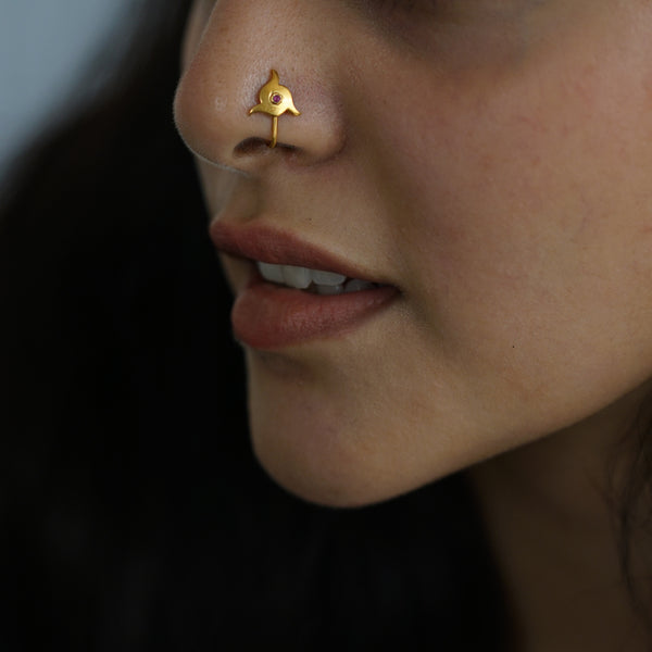 a close up of a person with a nose piercing
