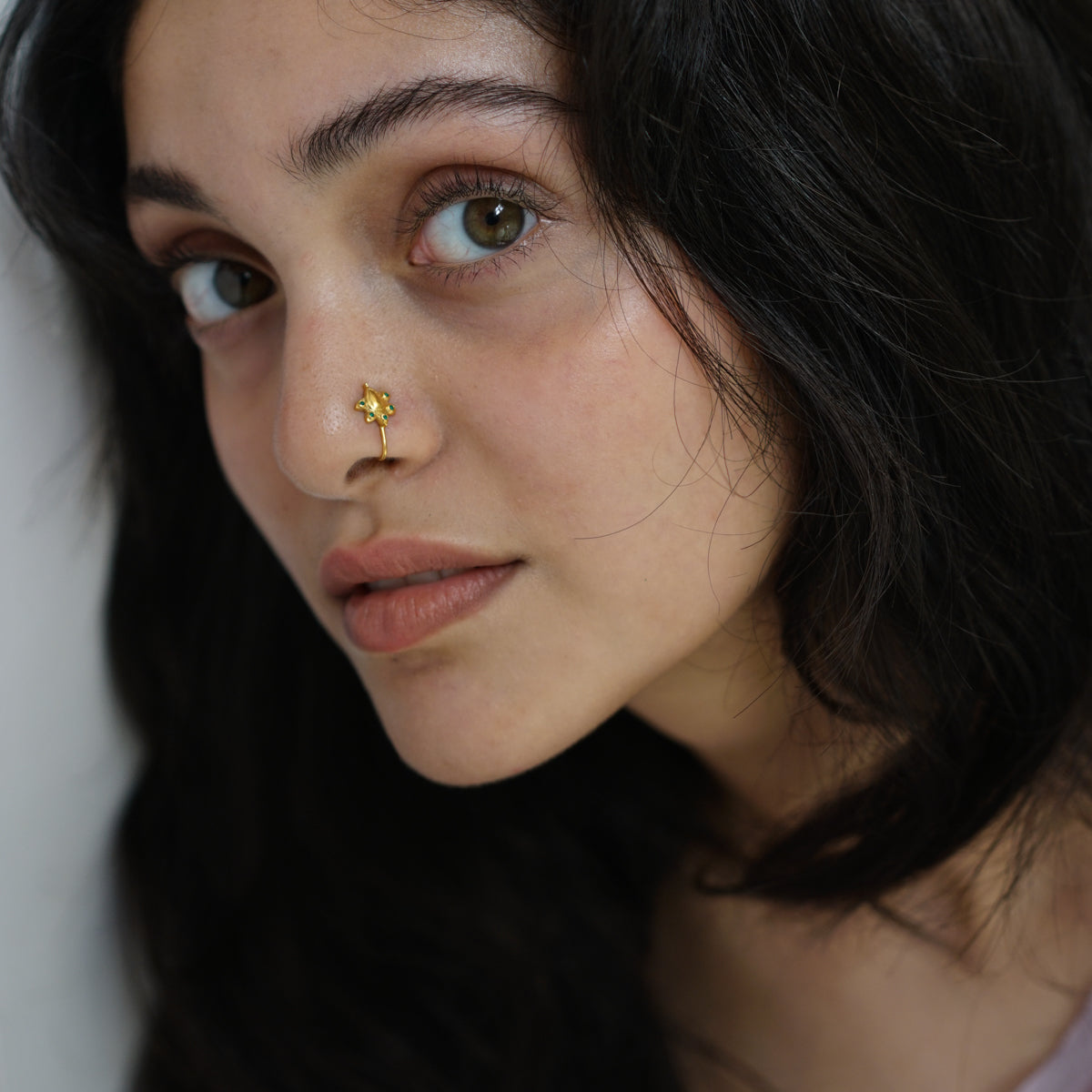 a close up of a person with a nose piercing