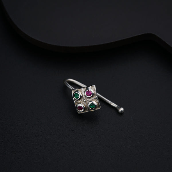 a close up of a pair of earrings on a black surface