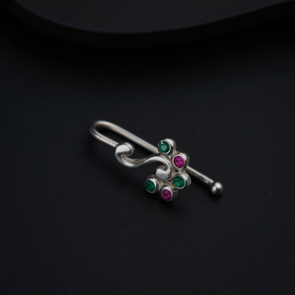 a close up of a pair of earrings on a black surface