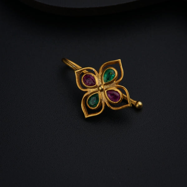 a close up of a brooch on a black surface