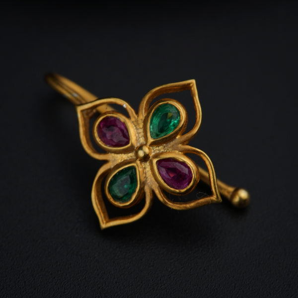 a close up of a flower shaped brooch