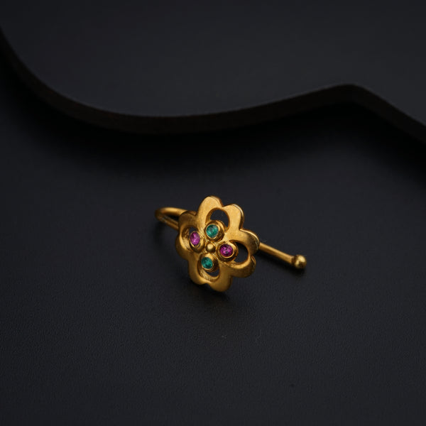a close up of a gold ring on a black surface