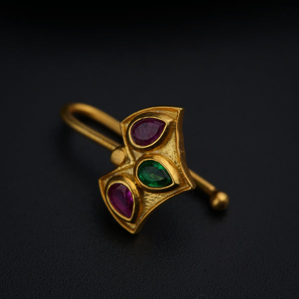 a close up of a brooch on a black surface