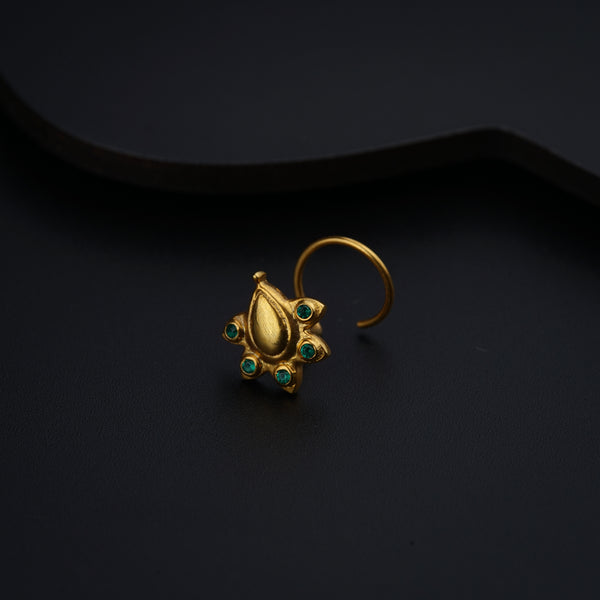 a close up of a gold ring on a black surface