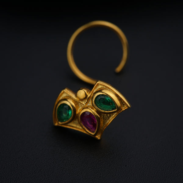 a close up of a pair of earrings on a black surface