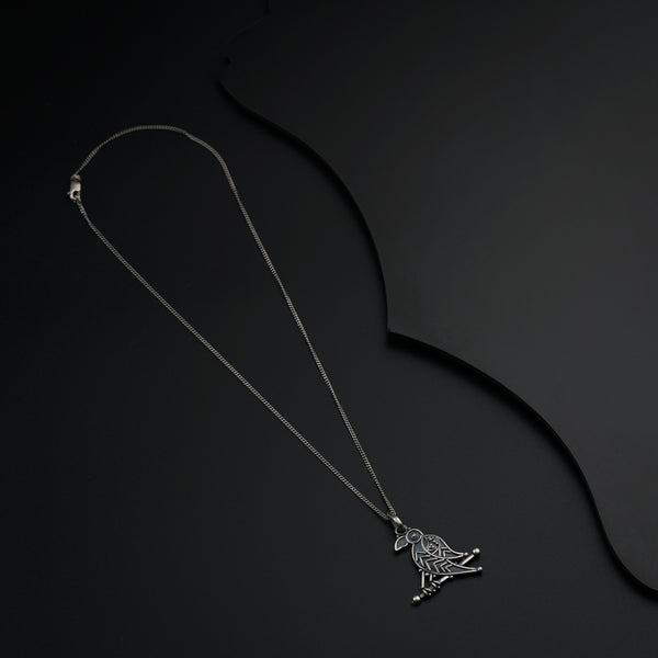 a necklace with a bird on it on a black background