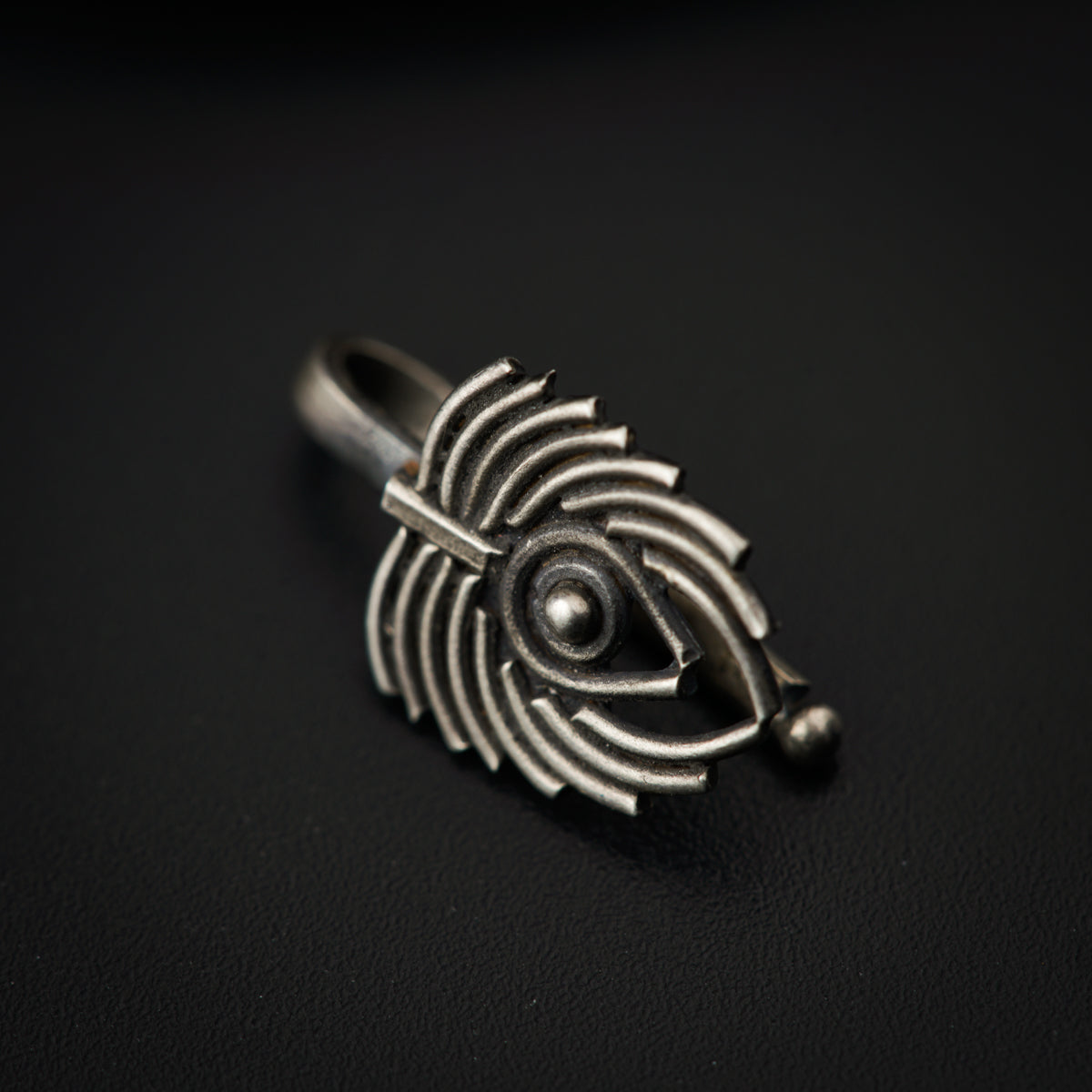 a silver ring with a spiral design on it